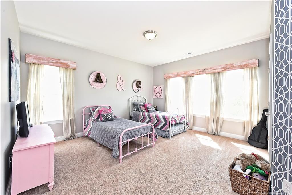 3004 Fallondale Road, Unit 906 Waxhaw, NC 28173 - Photo 16 of 24 a bedroom with two beds and a large window