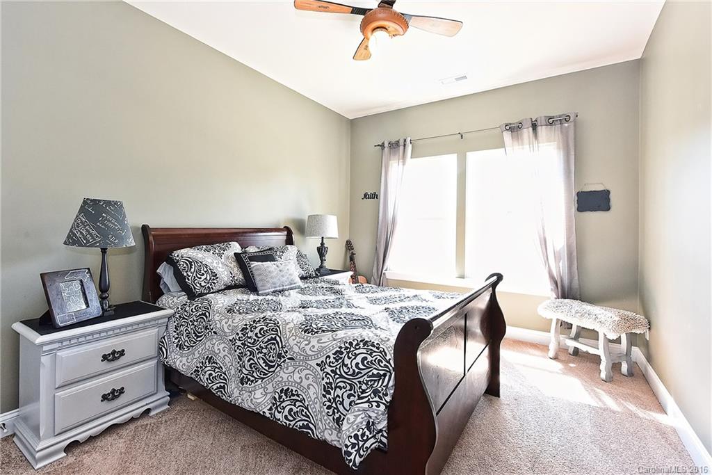 3004 Fallondale Road, Unit 906 Waxhaw, NC 28173 - Photo 18 of 24 a bedroom with a bed and a chandelier