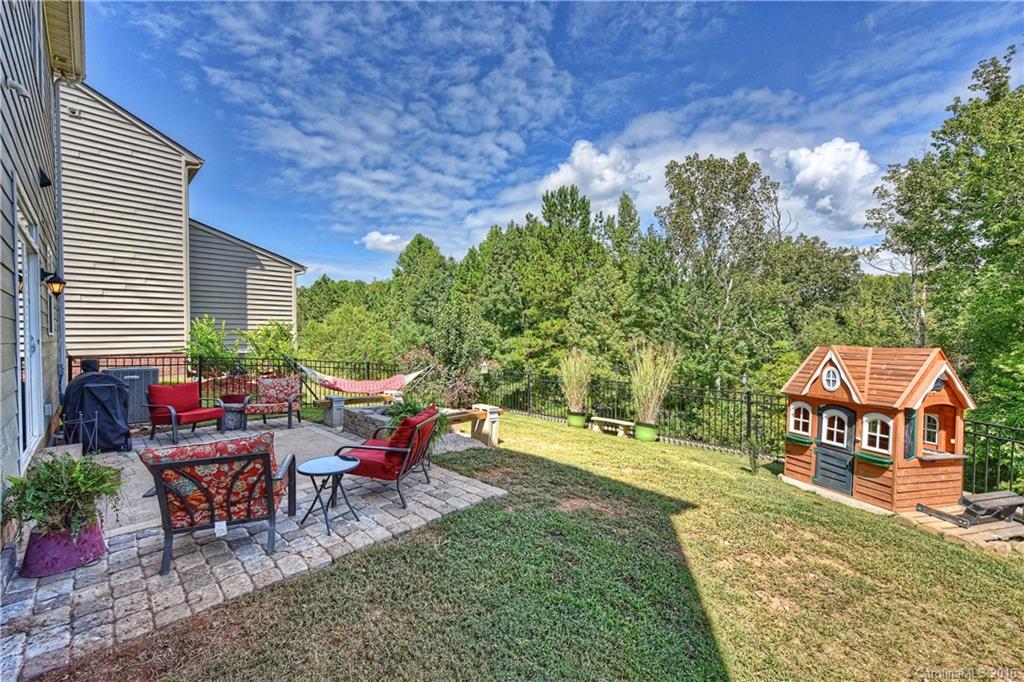 3004 Fallondale Road, Unit 906 Waxhaw, NC 28173 - Photo 21 of 24 a view of a chairs and tables in the backyard of the house