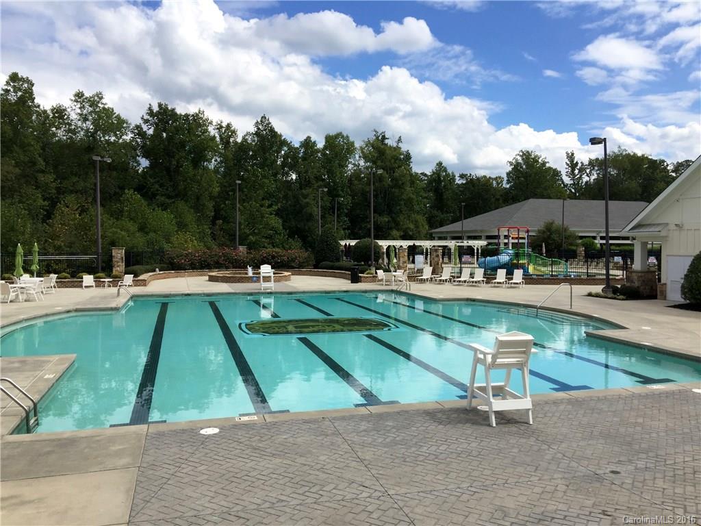3004 Fallondale Road, Unit 906 Waxhaw, NC 28173 - Photo 24 of 24 a view of swimming pool with seating area and trees in the background