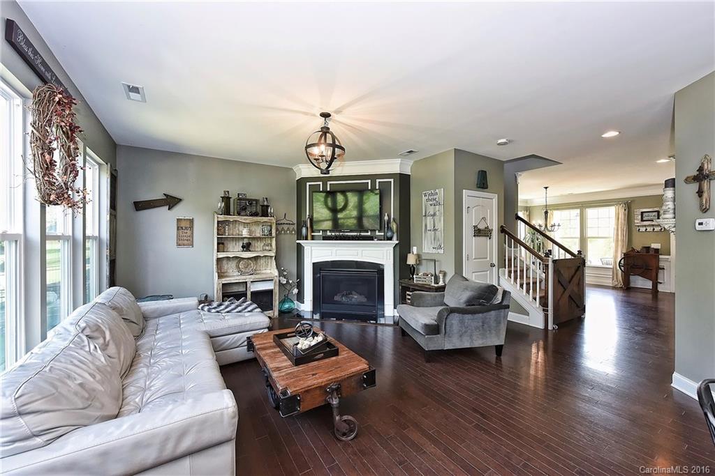 3004 Fallondale Road, Unit 906 Waxhaw, NC 28173 - Photo 5 of 24 a living room with fireplace furniture and a wooden floor