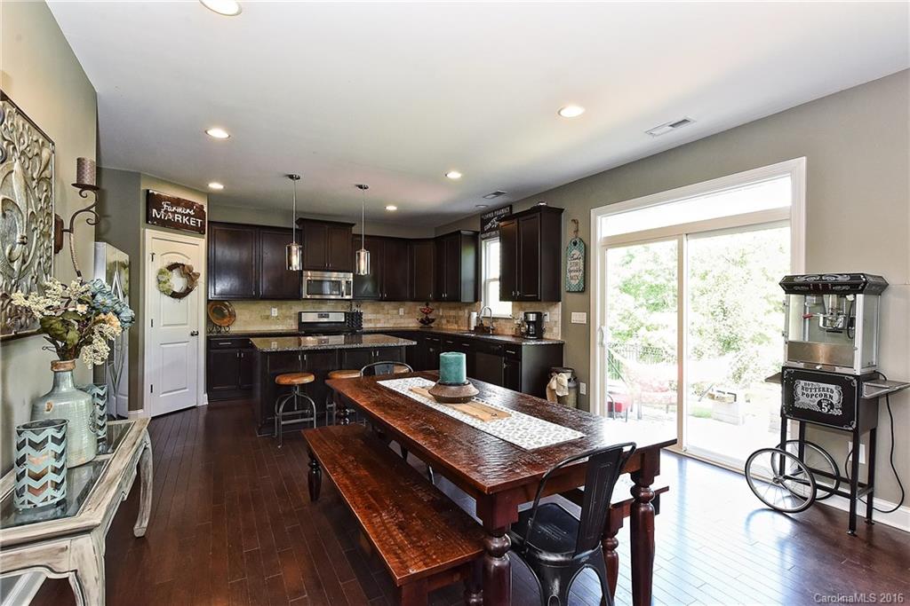 3004 Fallondale Road, Unit 906 Waxhaw, NC 28173 - Photo 7 of 24 a open dining room with stainless steel appliances kitchen island granite countertop a table chairs and a open kitchen view