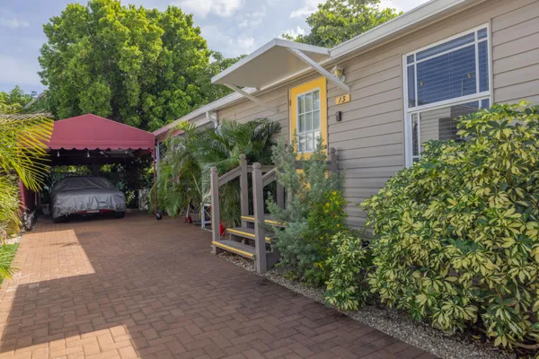a view of a house with a yard and sitting area