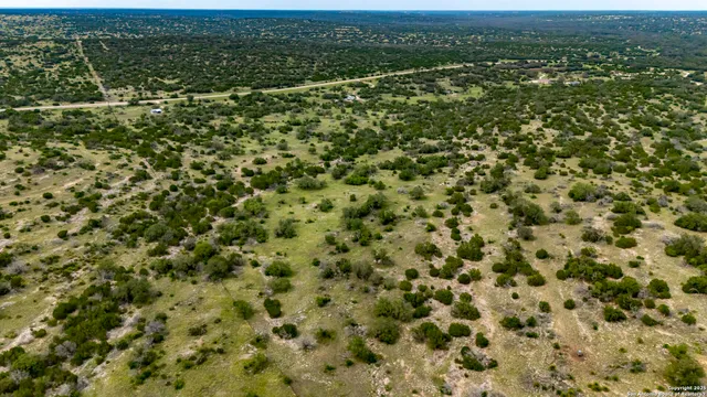 an aerial view of residential houses with city view