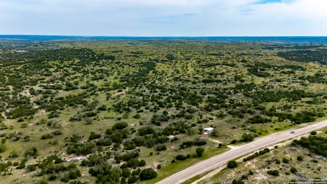 a view of a green field with an outdoor space