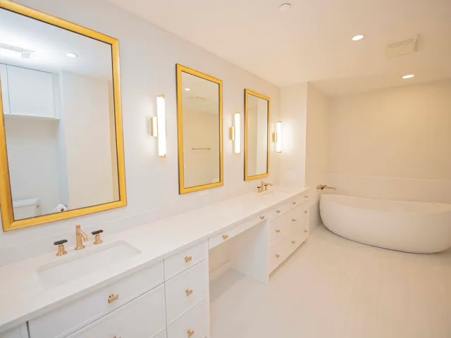 a bathroom with sink mirror and vanity