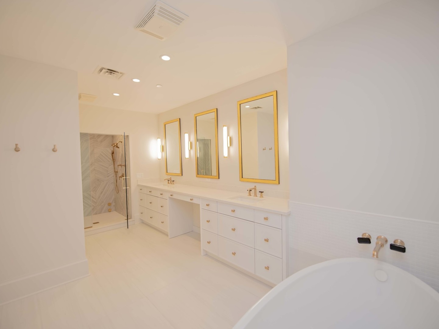 132 East Delaware Place, Unit 620507 Chicago, IL 60611 - Photo 16 of 22 a spacious bathroom with a double vanity sink a mirror and a bathtub