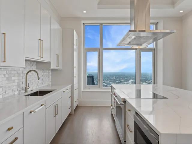 a kitchen with stainless steel appliances granite countertop a sink and a stove