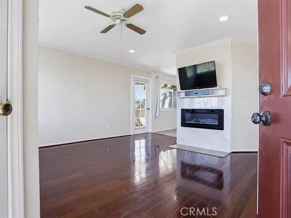 a living room with furniture wooden floor and a flat screen tv