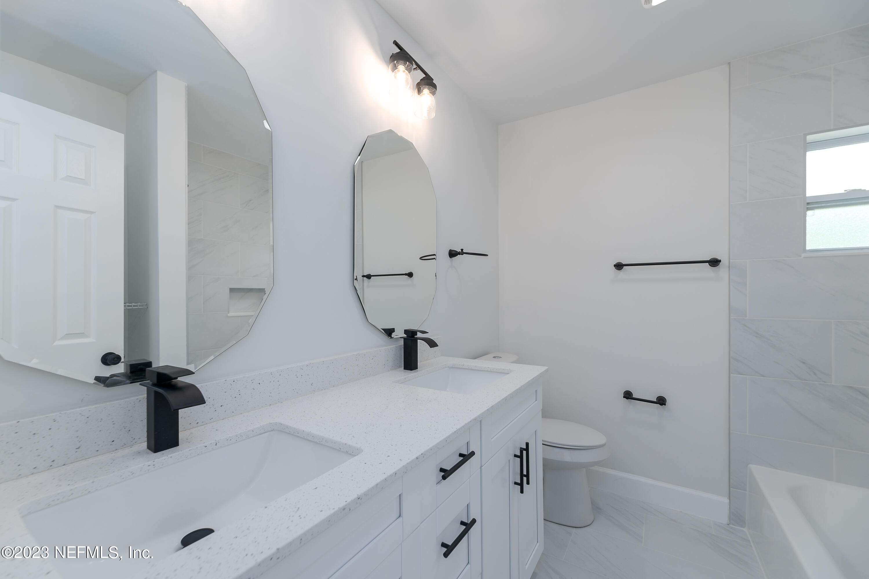 7425 Centauri Road Jacksonville, FL 32210 - Photo 12 of 23 a bathroom with a sink a toilet and a mirror