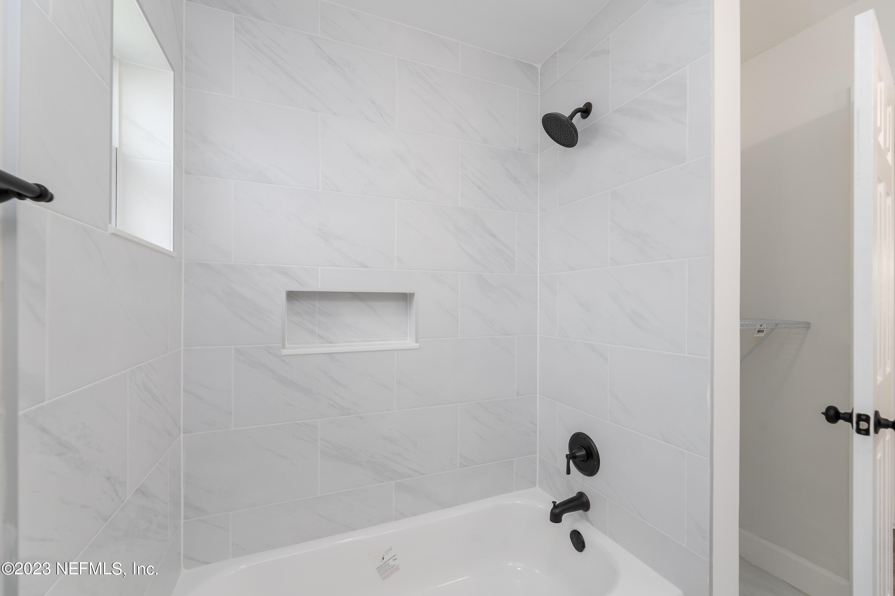 7425 Centauri Road Jacksonville, FL 32210 - Photo 13 of 23 a bathroom with a bathtub