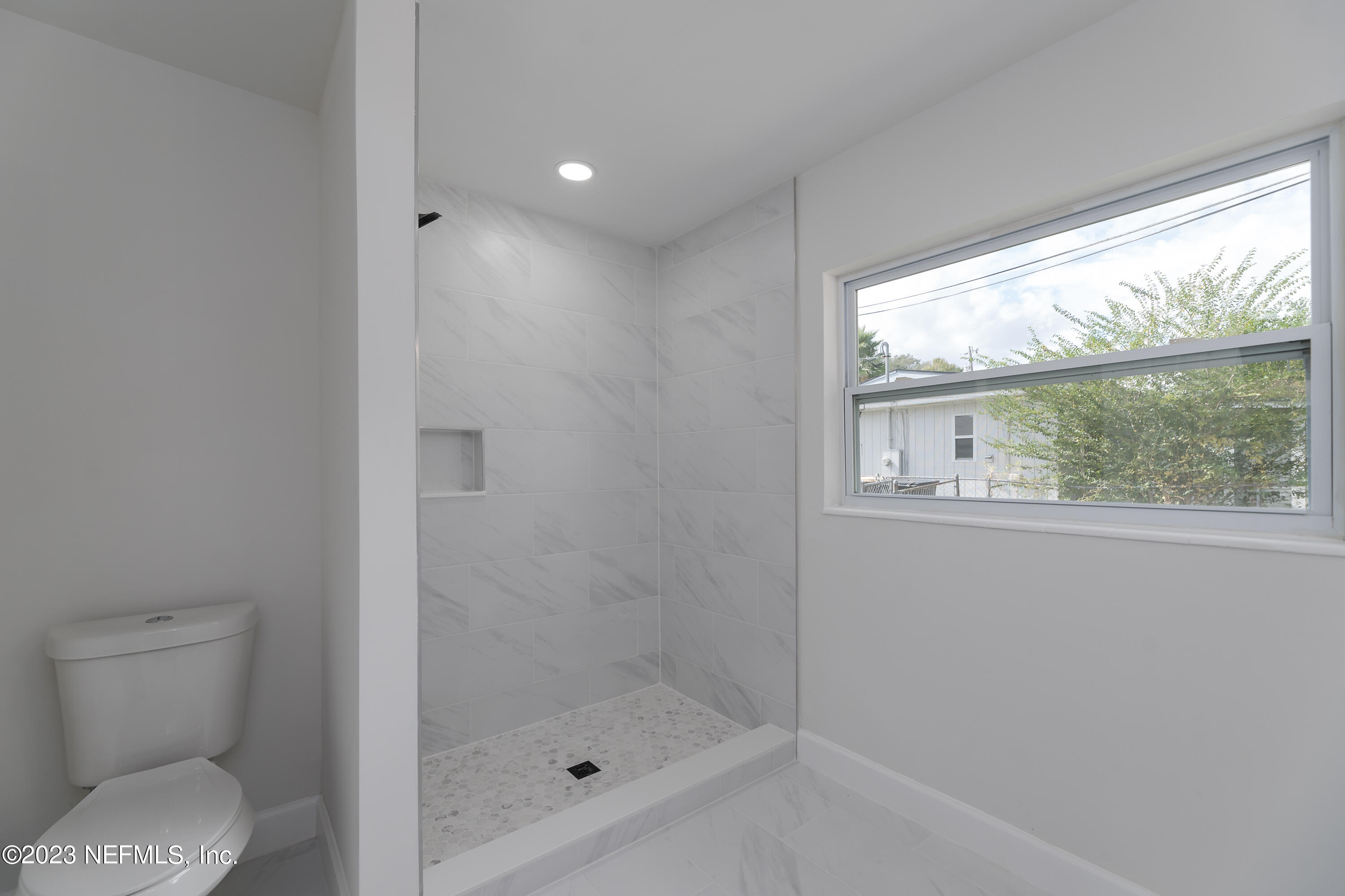 7425 Centauri Road Jacksonville, FL 32210 - Photo 19 of 23 a bathroom with a shower and toilet