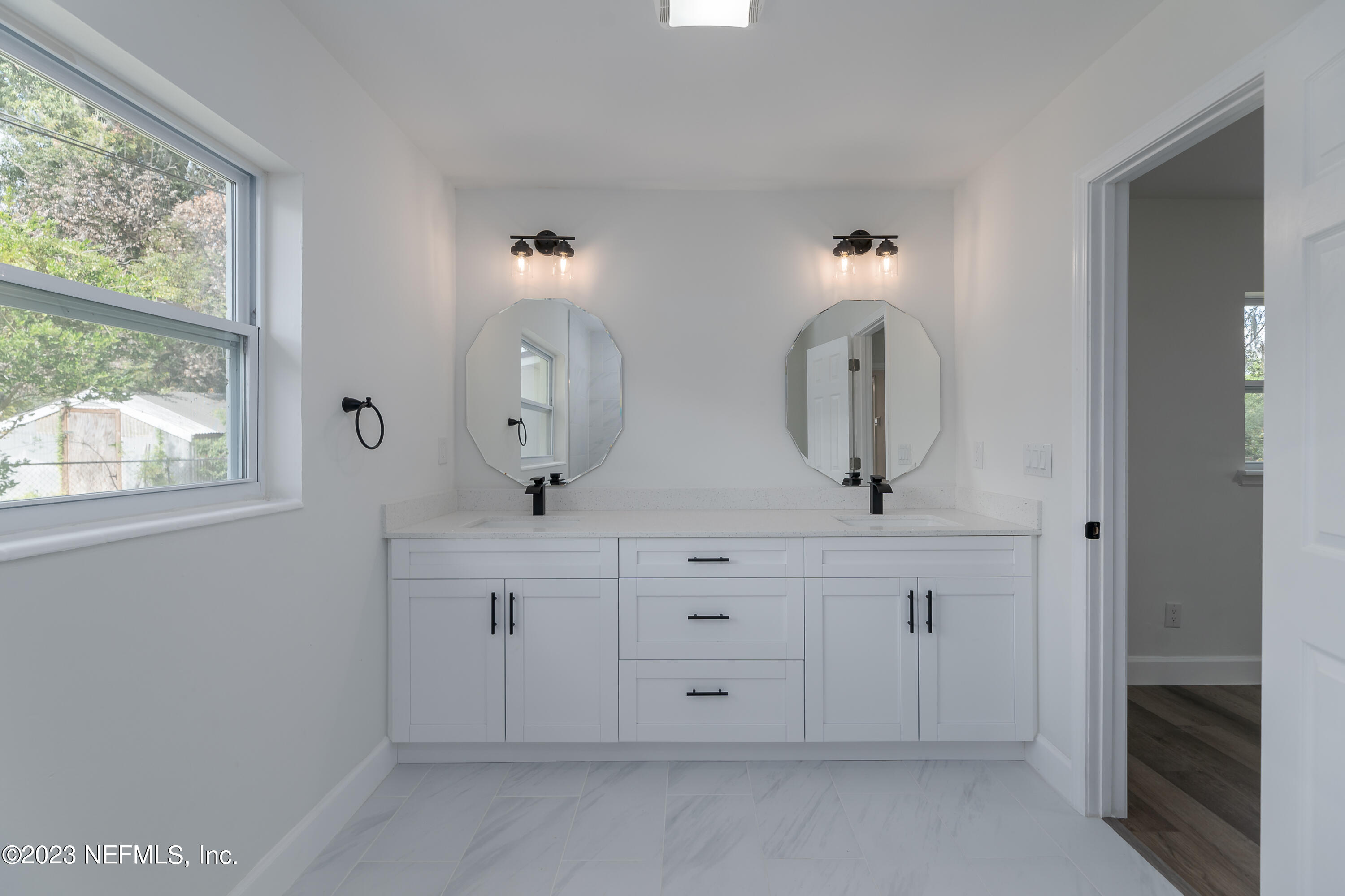 7425 Centauri Road Jacksonville, FL 32210 - Photo 20 of 23 a bathroom with a double vanity sink and a mirror