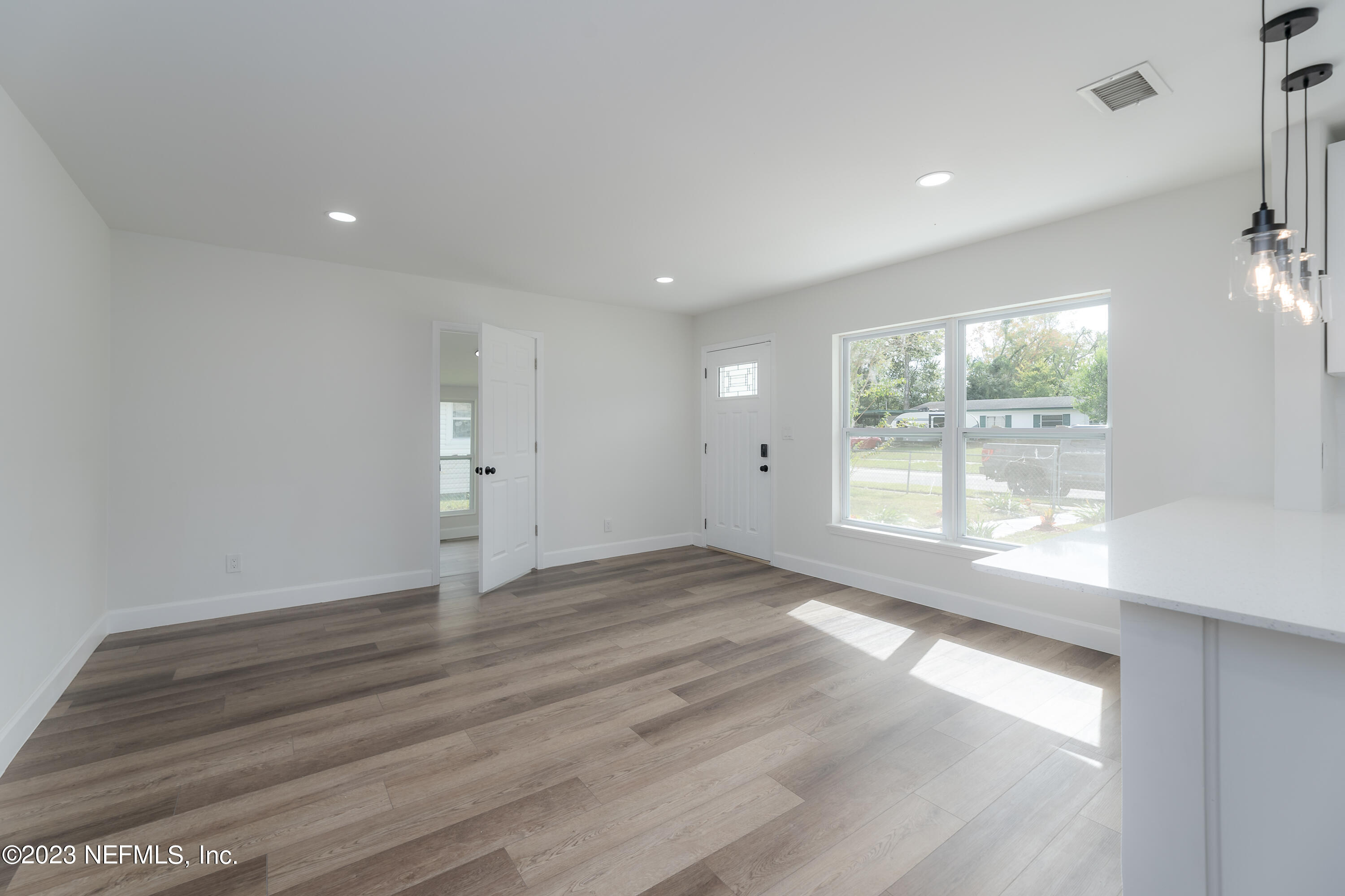 7425 Centauri Road Jacksonville, FL 32210 - Photo 5 of 23 an empty room with wooden floor and windows