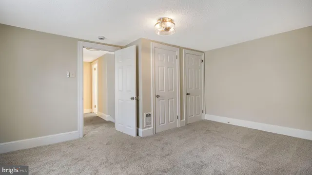 a view of an empty room and a bathroom
