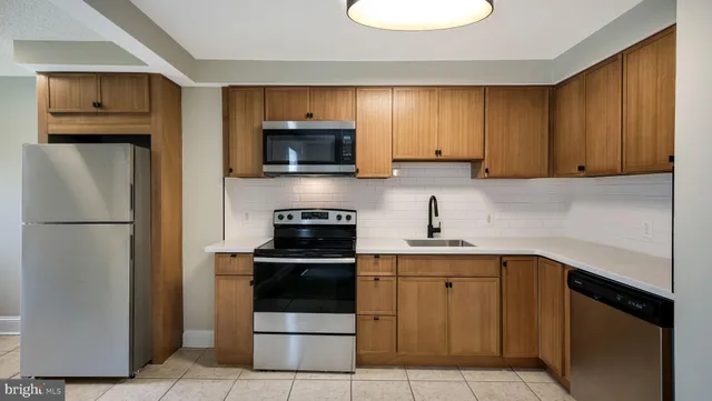 a kitchen with a sink a stove and refrigerator