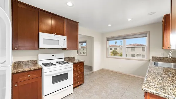 a kitchen with stainless steel appliances granite countertop a stove and a refrigerator