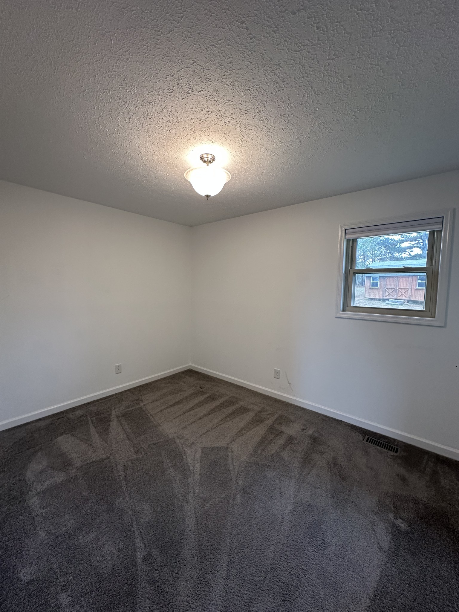 3508 Highway 259 Portland, TN 37148 - Photo 16 of 18 an empty room with a night stand and a window