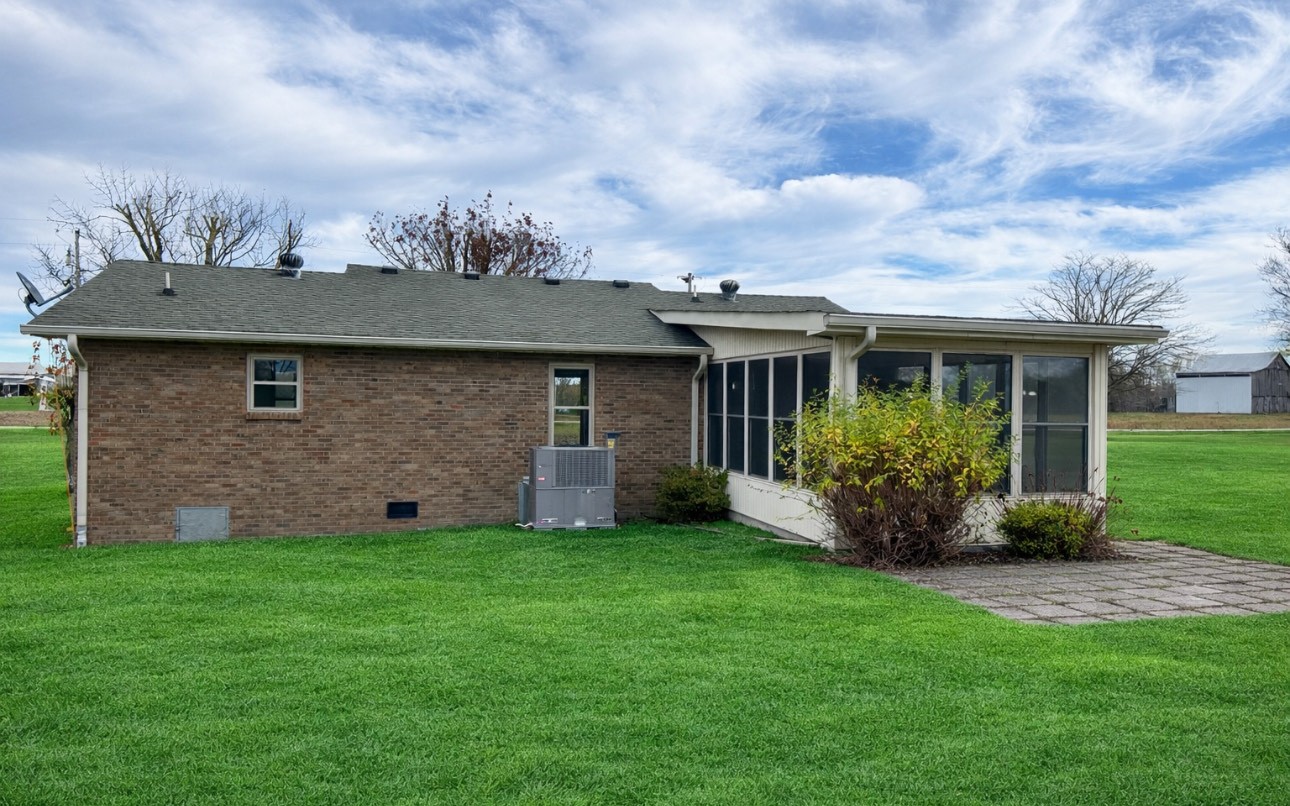 3508 Highway 259 Portland, TN 37148 - Photo 3 of 18 a view of a house with brick walls and a yard with potted plants