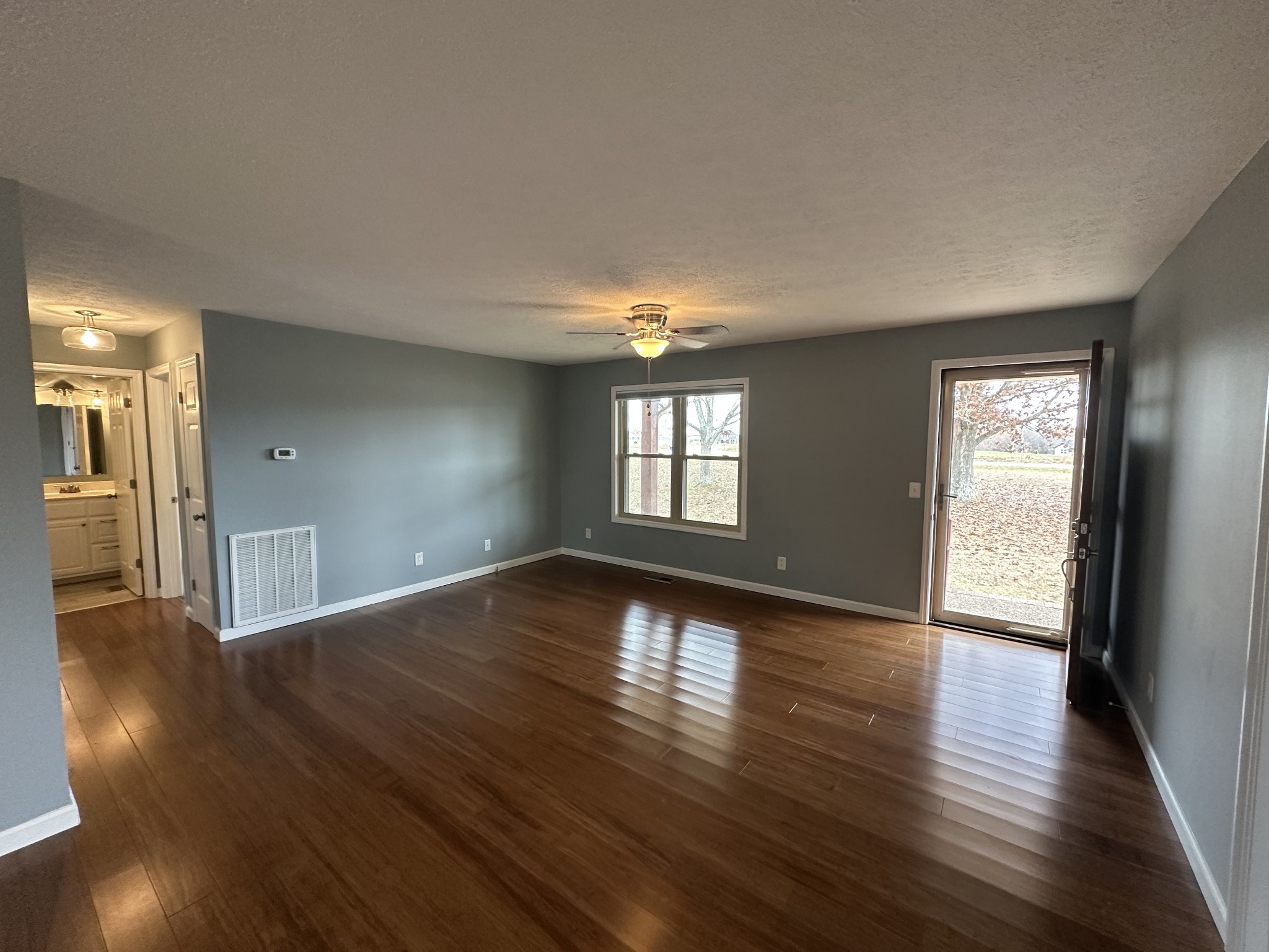 3508 Highway 259 Portland, TN 37148 - Photo 6 of 18 a view of an empty room with wooden floor and a window