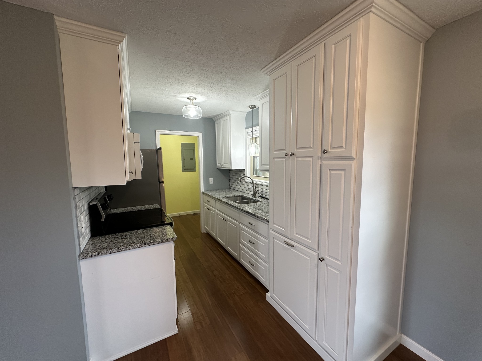 3508 Highway 259 Portland, TN 37148 - Photo 7 of 18 a kitchen with granite countertop a refrigerator and a stove top oven