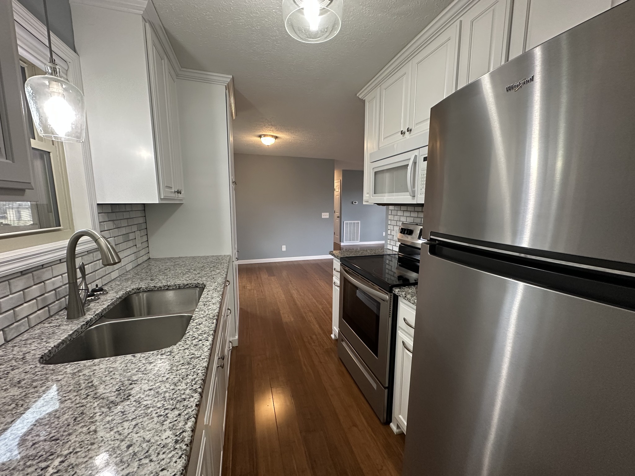3508 Highway 259 Portland, TN 37148 - Photo 9 of 18 a kitchen with stainless steel appliances granite countertop a refrigerator a sink a stove and a microwave oven