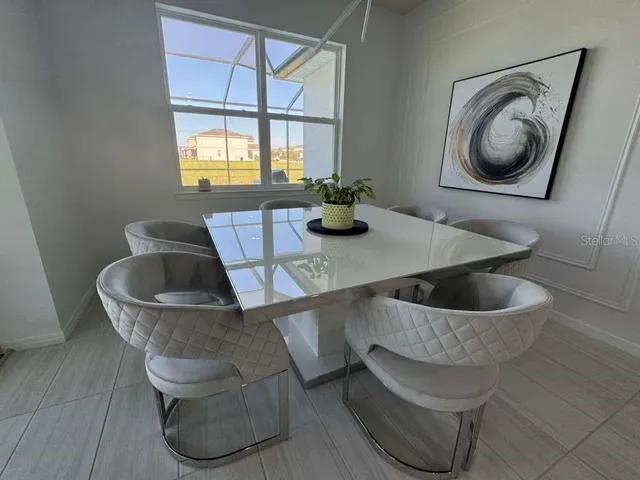 a kitchen with a table and a chair