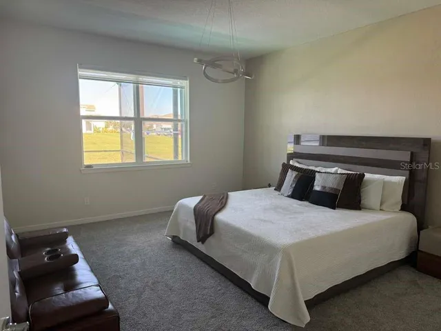 a bedroom with a bed and window