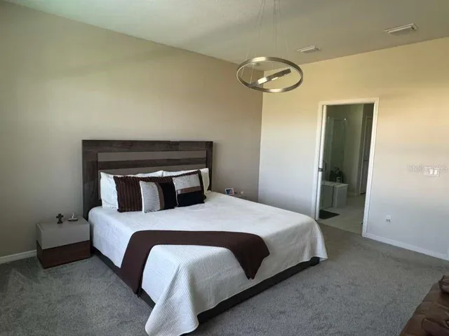 a bedroom with a bed and a mirror