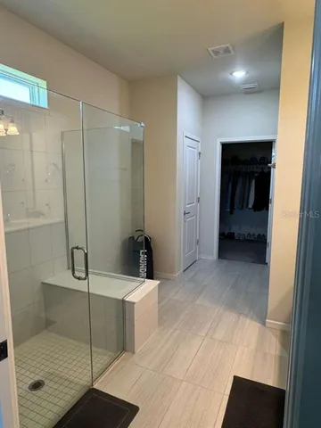 a bathroom with a shower and a sink