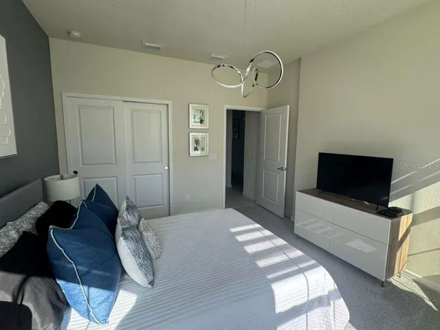 a bedroom with bed and a tv