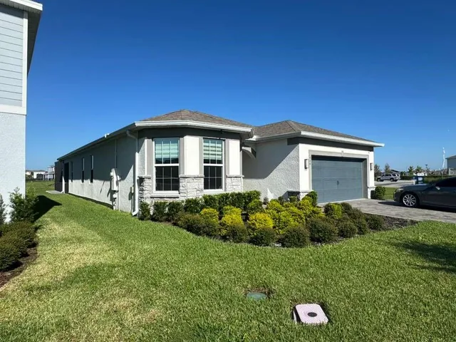 a front view of house with a garden