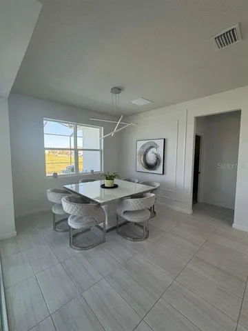a living room with table furniture and a window