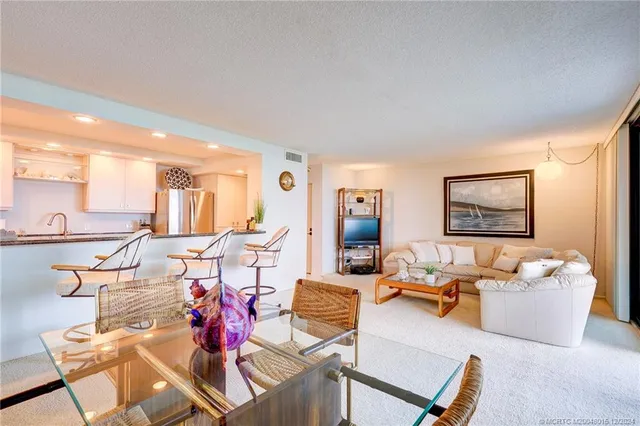 a living room with furniture a flat screen tv and a window