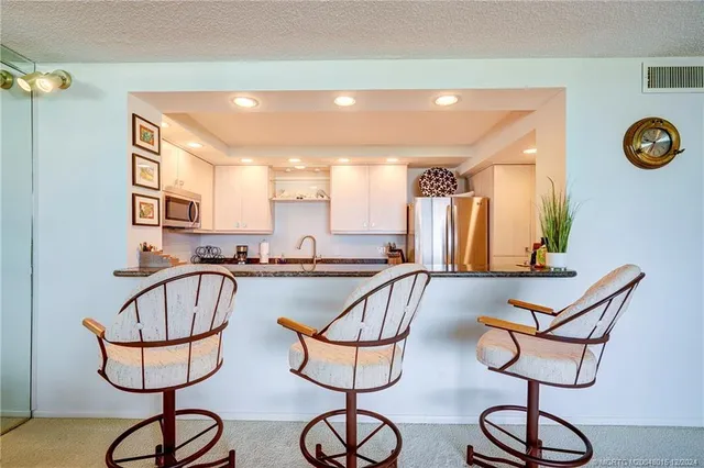 a kitchen with counter top space and windows
