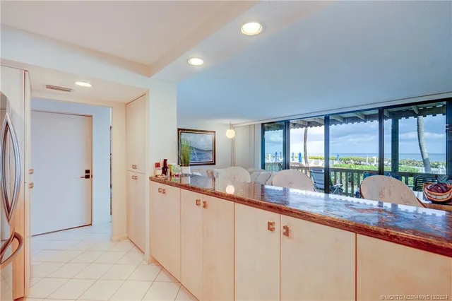 a kitchen with stainless steel appliances granite countertop a sink a stove and washer