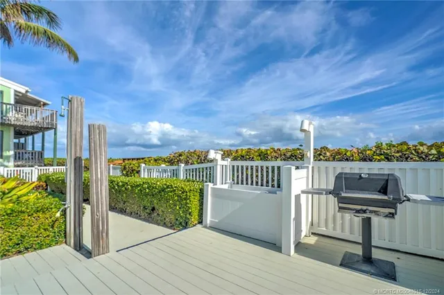 a view of a patio with wooden floor and city view