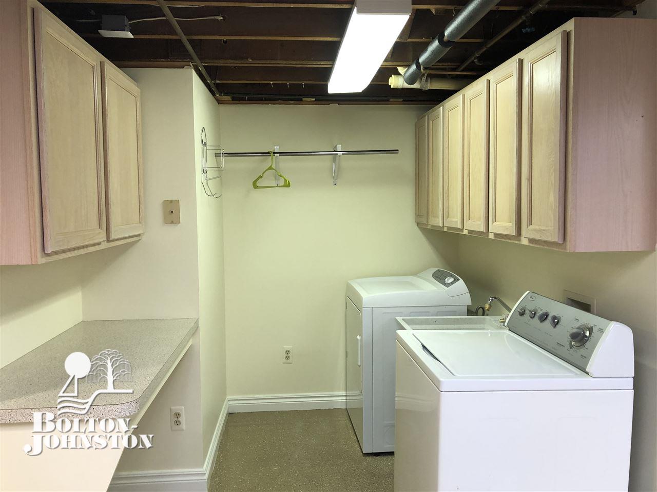 627 Lincoln Road Grosse Pointe, MI 48230 - Photo 37 of 60 Convenient modern laundry room with cupboards, hanging space and counter for folding. Washer and dryer included.