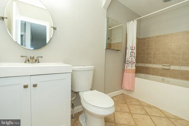 an empty room with ceiling fan and window