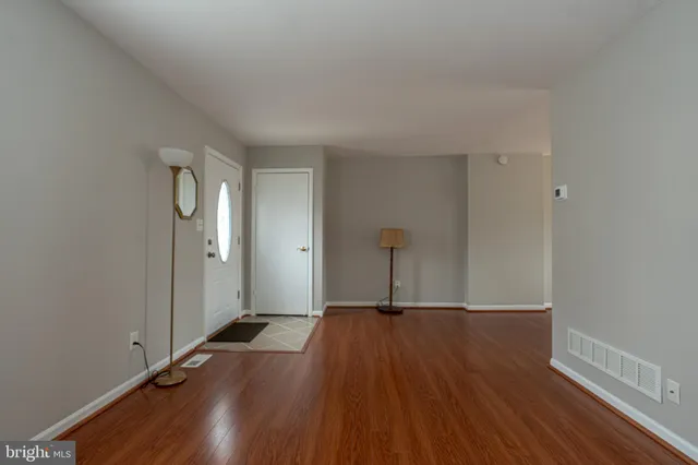 a view of a room with wooden floor