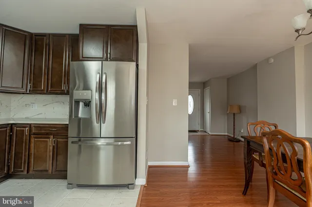 a metallic refrigerator freezer sitting in a kitchen