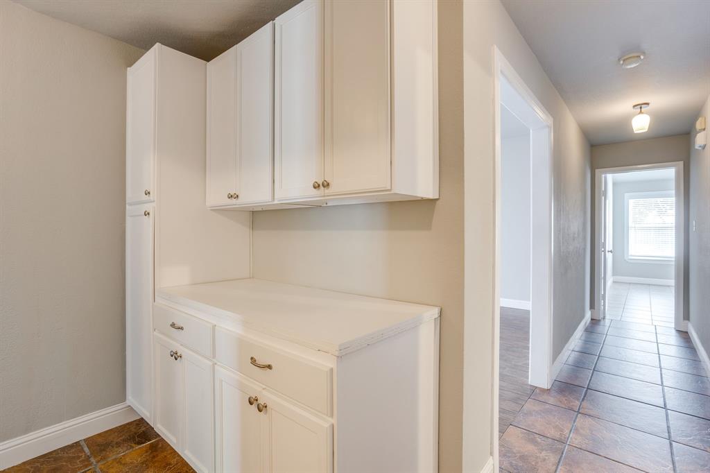 9825 Stoney Bridge Road Fort Worth, TX 76108 - Photo 31 of 40 Hall storage and folding counter near laundry room