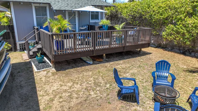 a view of a deck with furniture and garden