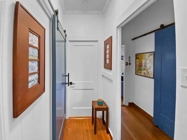 a view of a room with wooden floor and windows