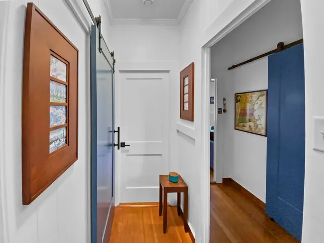 a view of a room with wooden floor and windows