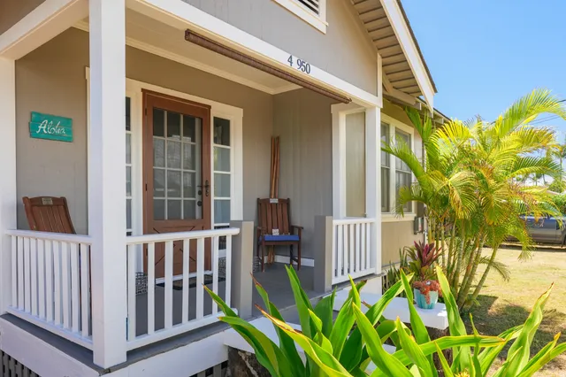 a view of a porch with a table and chairs