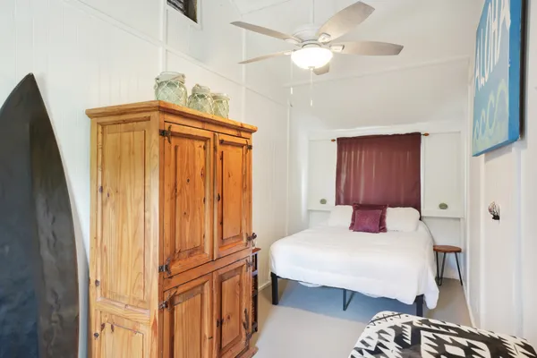 a bedroom with a bed dresser and a window