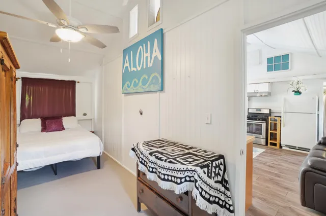 a bedroom with a bed and a book shelf
