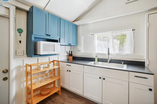 a kitchen with granite countertop cabinets and window