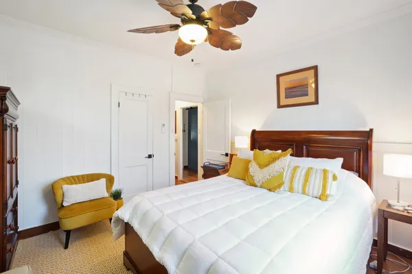 a bedroom with a bed and lamp